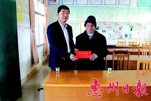 龙门县工商联主席黎伟松（左）慰问困难群众。
